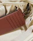 Victoria Hyde caramel genuine leather card holder, unisex & multifunctional. Features 10 card slots, 1 ticket slot, zippered coin pocket, and detachable side closure.