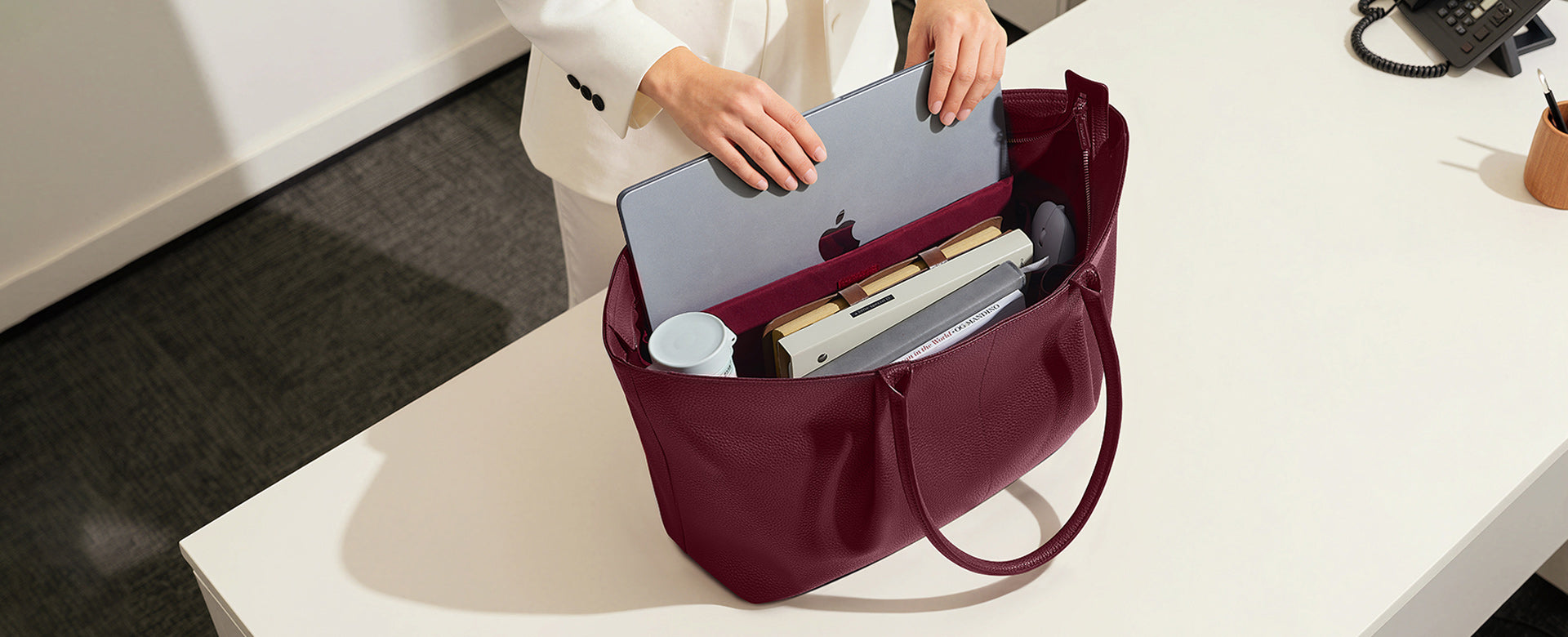 Die Ada Tote in Red: Optimal organization with 8 interior pockets and a secure, padded compartment for laptops up to 16 inches.