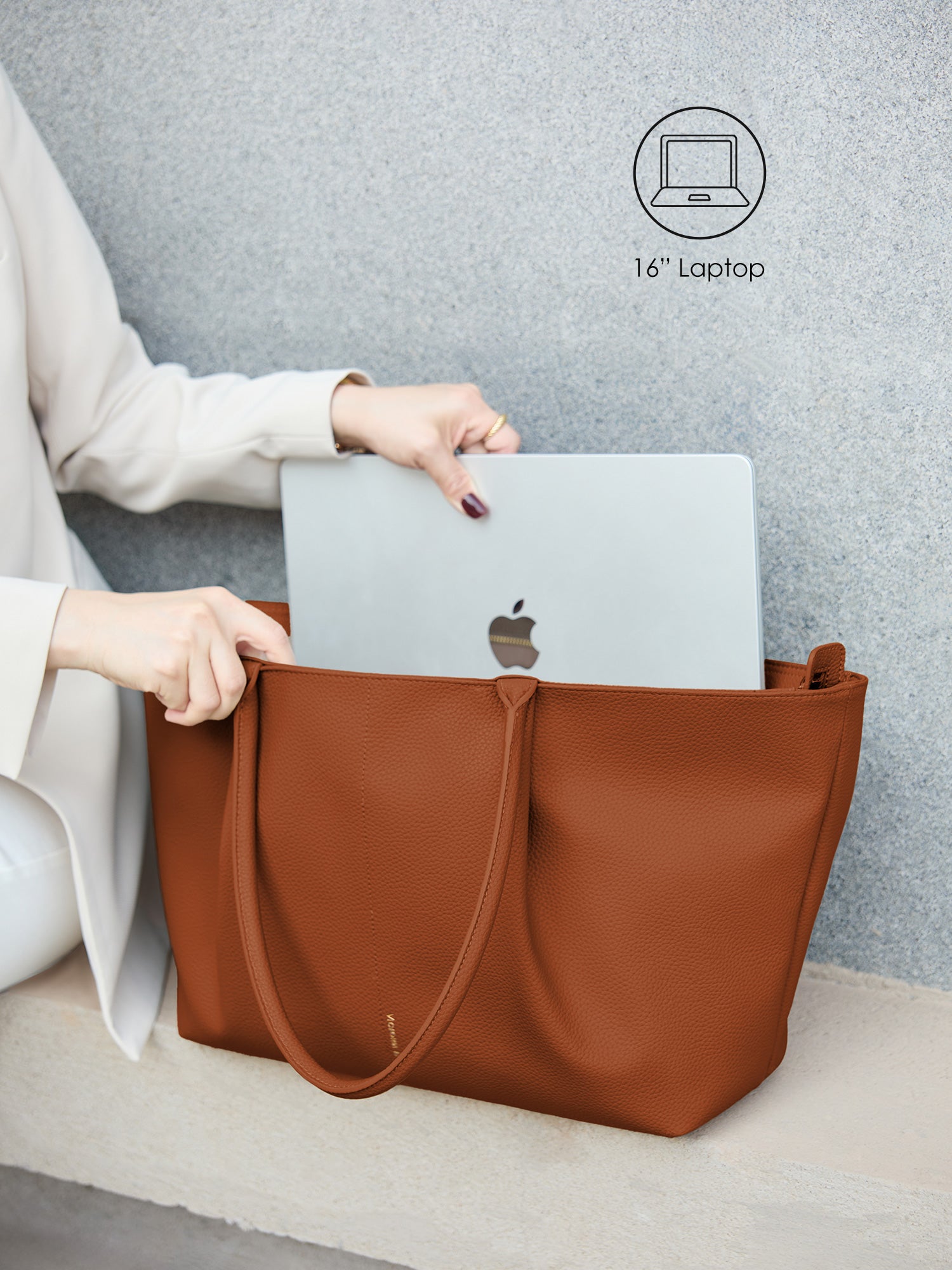 Victoria Hyde Ada brown laptop bag perfectly fitting a 16-inch laptop, demonstrating secure and easy access for professional daily commutes.