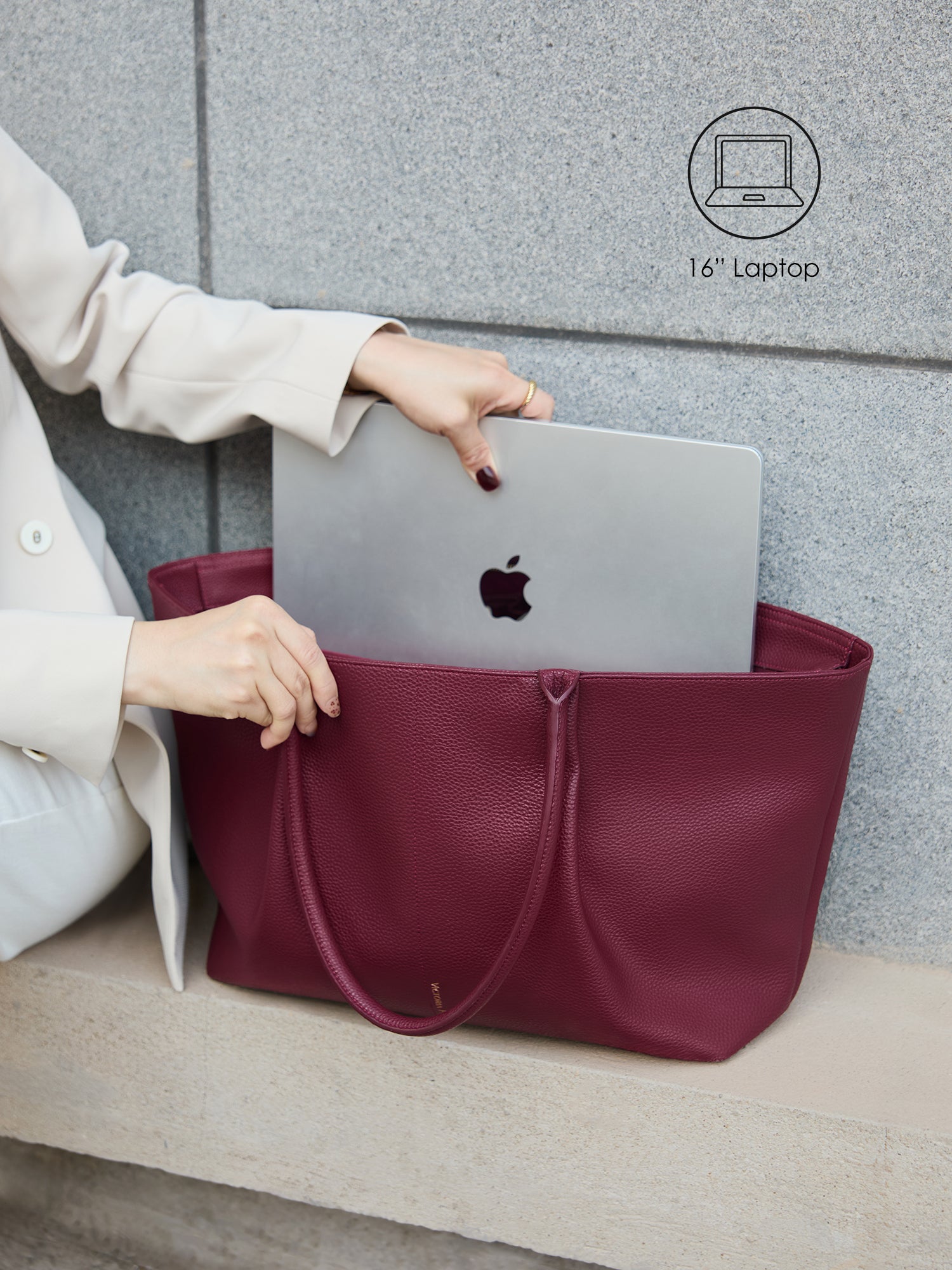 Victoria Hyde Ada red laptop bag perfectly fitting a 16-inch laptop, demonstrating secure and easy access for professional daily commutes.