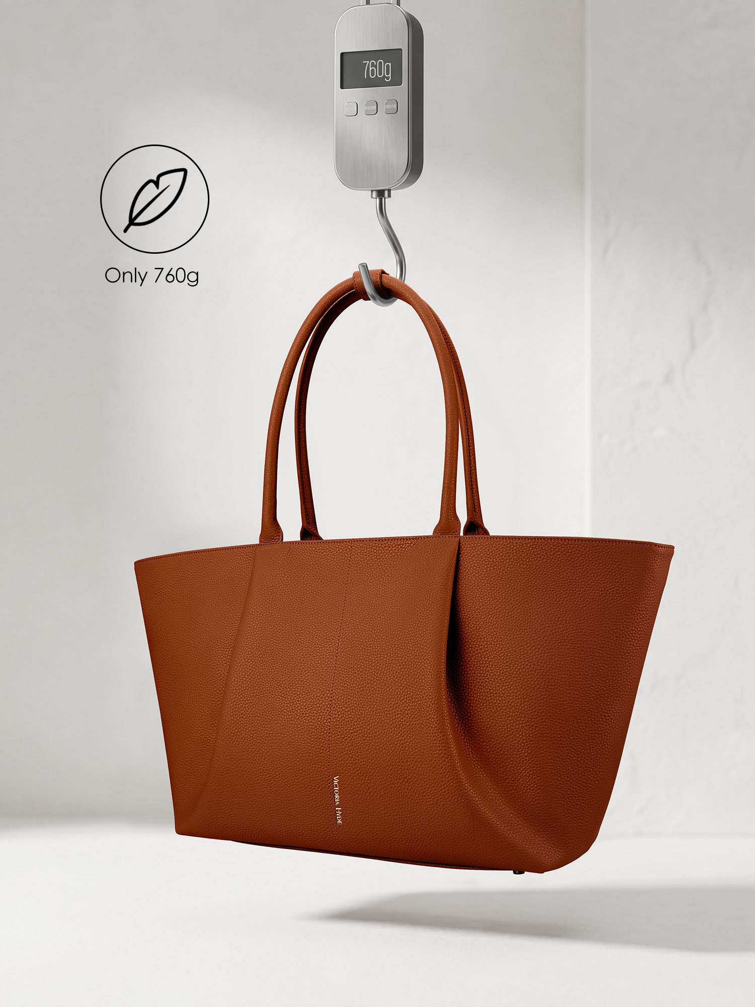 Victoria Hyde Ada brown laptop bag showing lightweight design, weighing only 760g, stylish vegan leather business bag for 16-inch laptops.