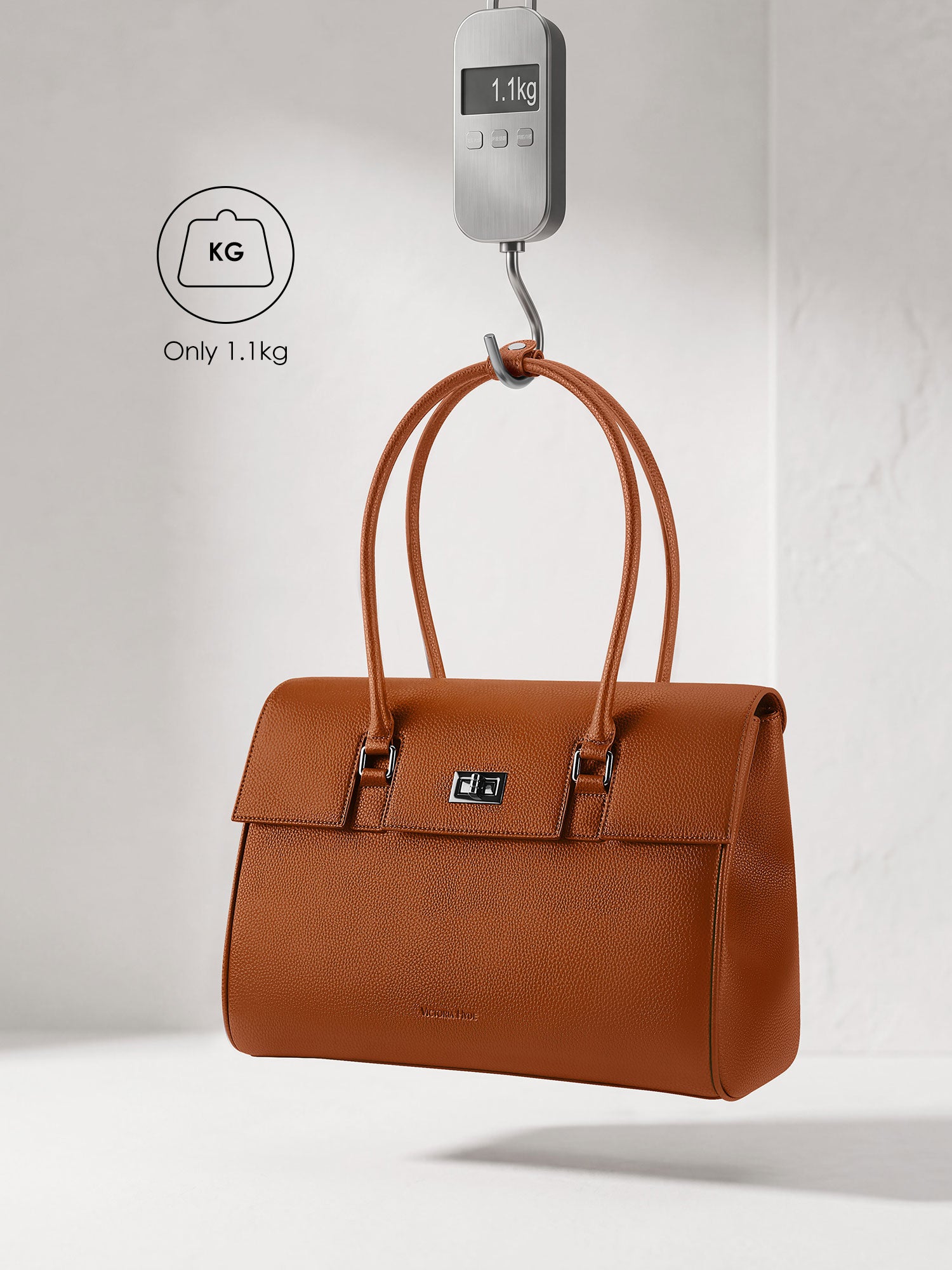 Victoria Hyde Jolene brown laptop bag showing lightweight design, weighing only 1.1kg, stylish vegan leather business bag for 16-inch laptops.