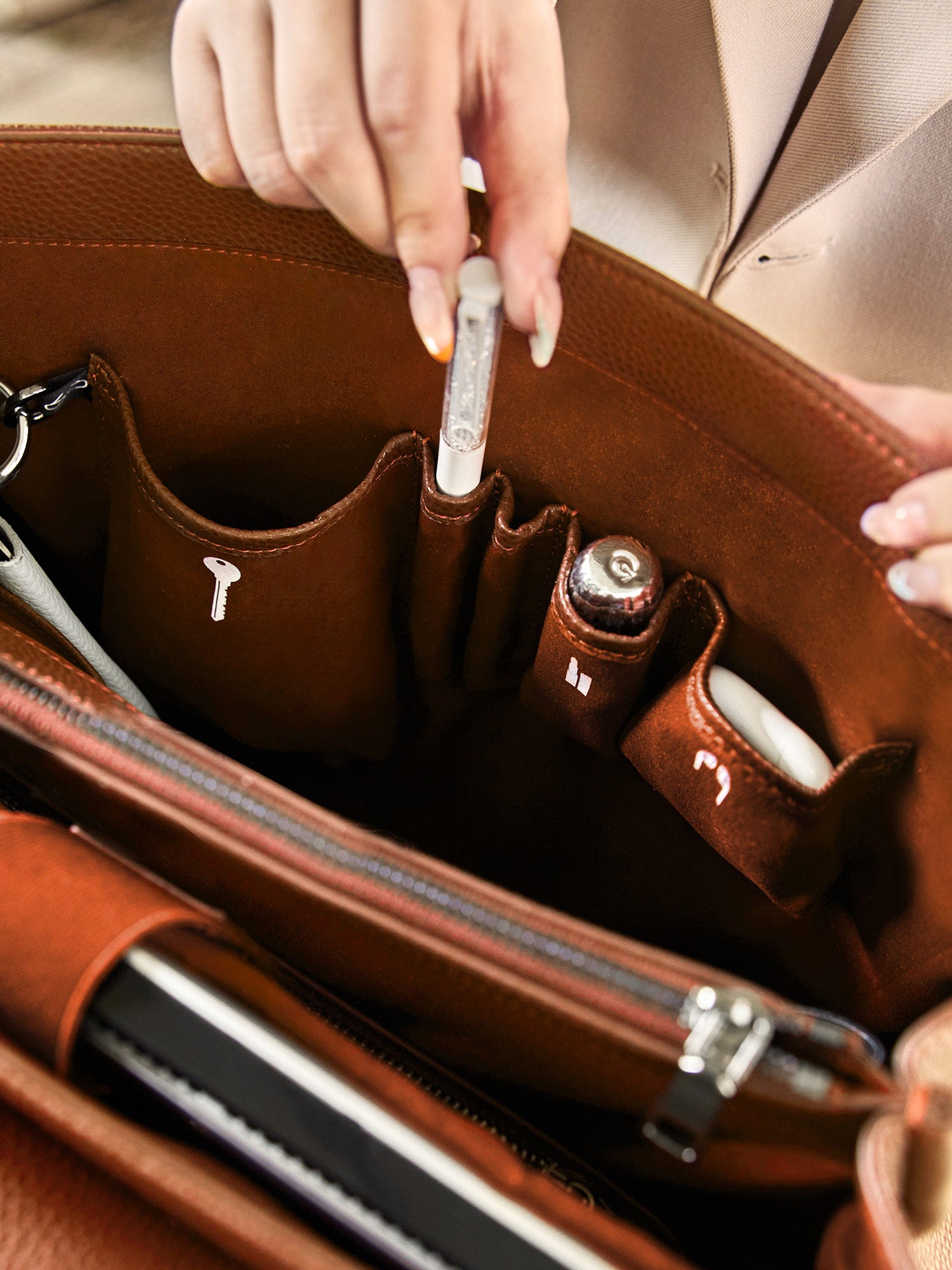 Victoria Hyde Jolene brown laptop bag interior showing organized pockets for smartphone, pens, and accessories, perfect for daily business essentials.