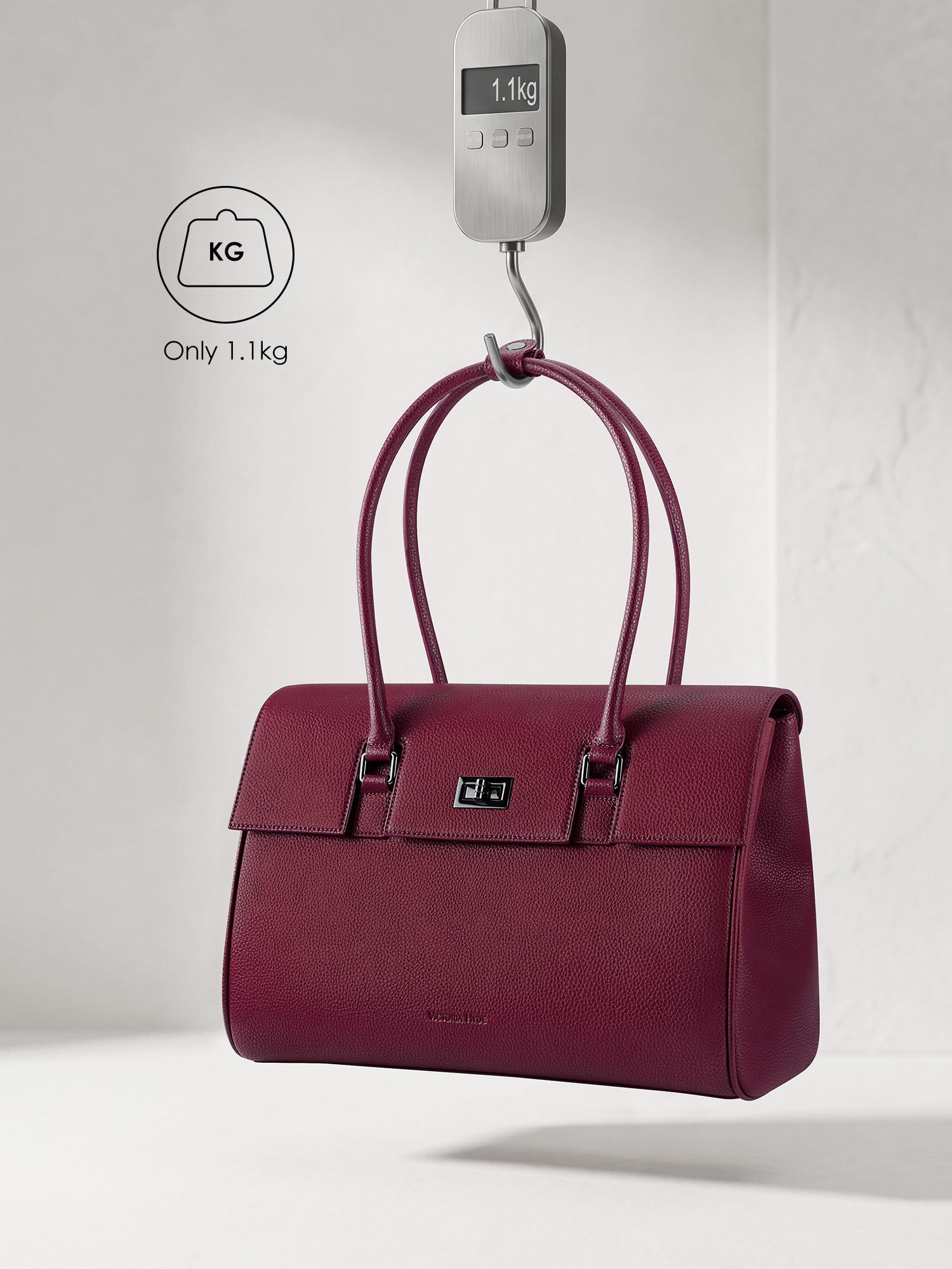 Victoria Hyde Jolene winered laptop bag showing lightweight design, weighing only 1.1kg, stylish vegan leather business bag for 16-inch laptops.