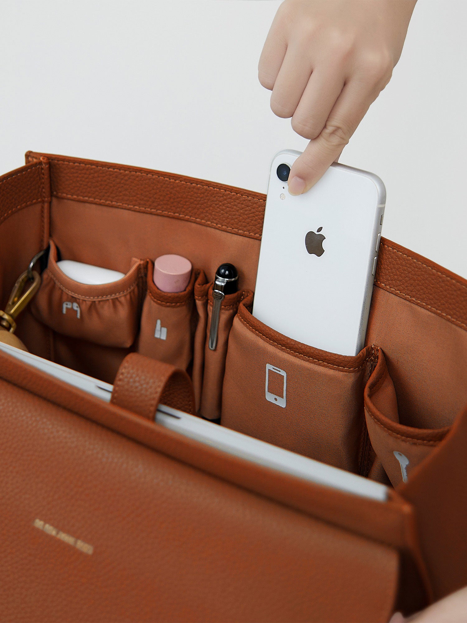 Victoria Hyde Potter brown laptop bag interior showing organized pockets for smartphone, pens, and accessories, perfect for daily business essentials.