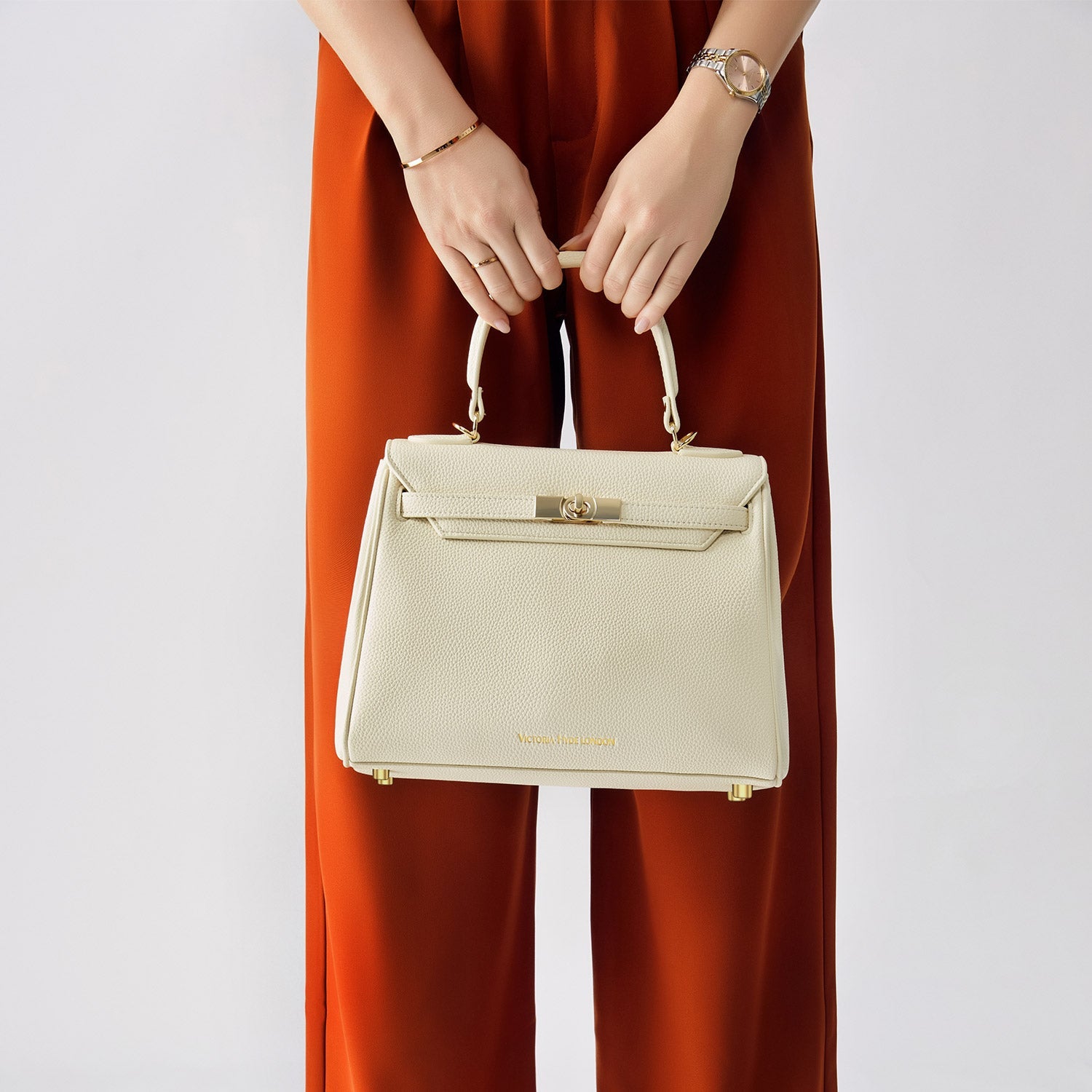 Victoria Hyde Victoria Moonlight White handbag in PU leather with gold hardware, detachable strap, organized interior for elegant daily use.