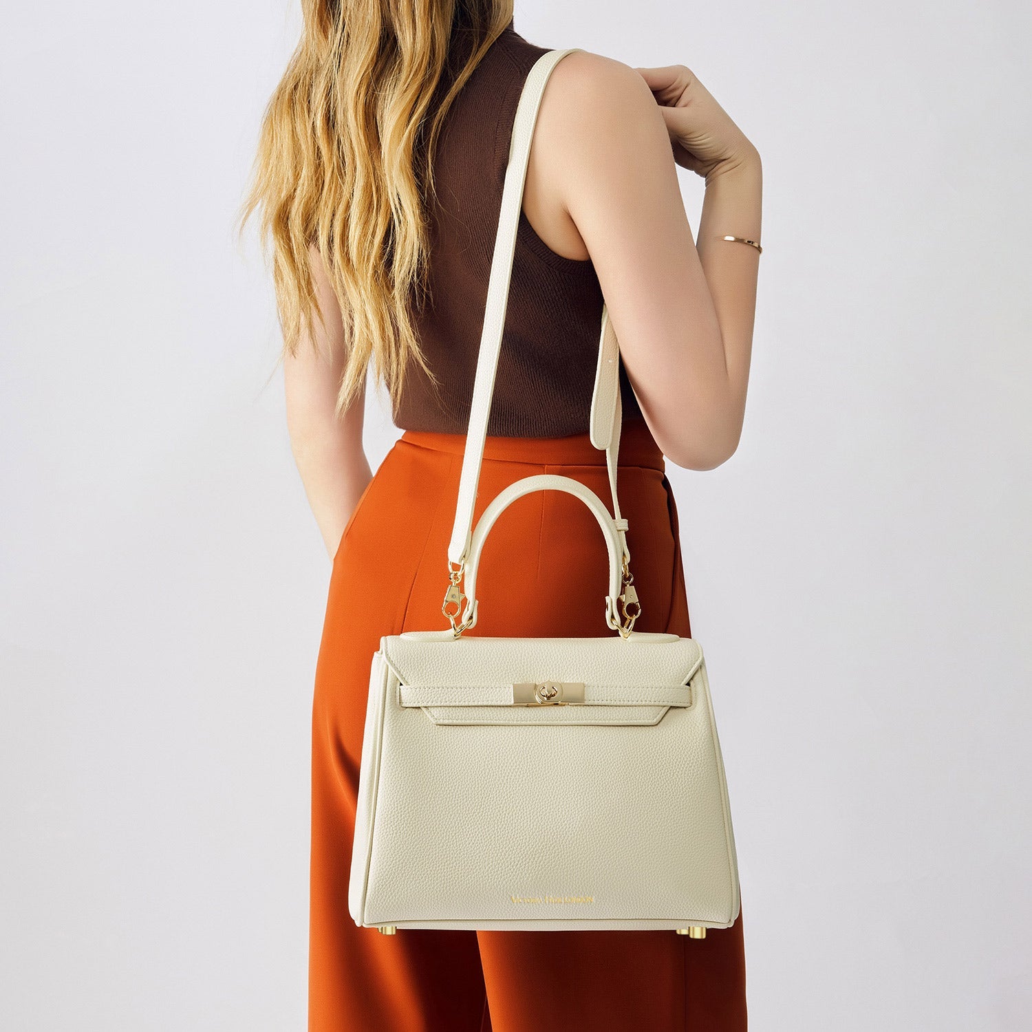 Victoria Hyde Victoria Moonlight White handbag in PU leather with gold hardware, detachable strap, organized interior for elegant daily use.