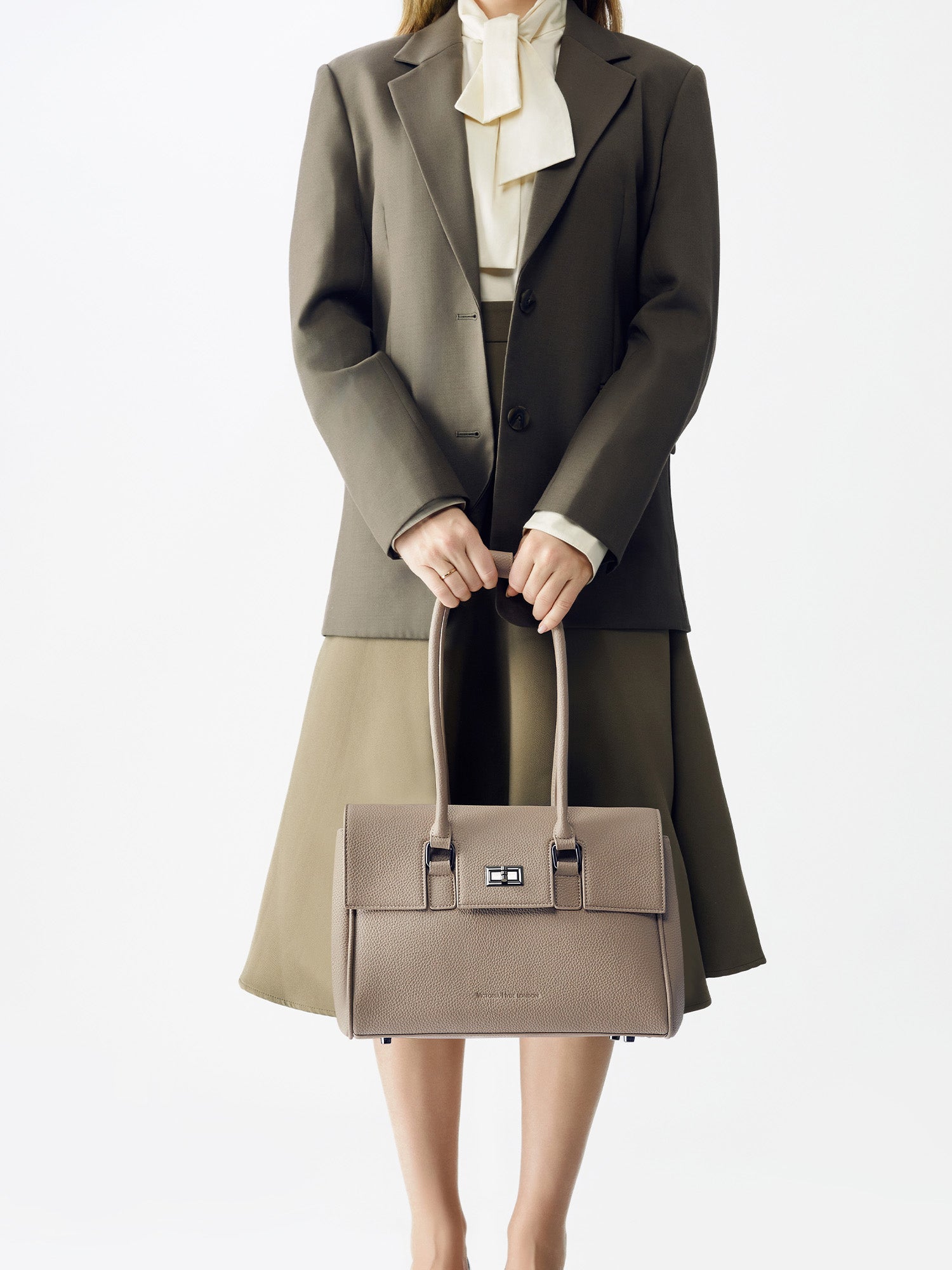 Victoria Hyde Jolene Small Beige work bag – fits 15" laptop, vegan leather, water-repellent, hidden luggage strap, perfect for working mothers.