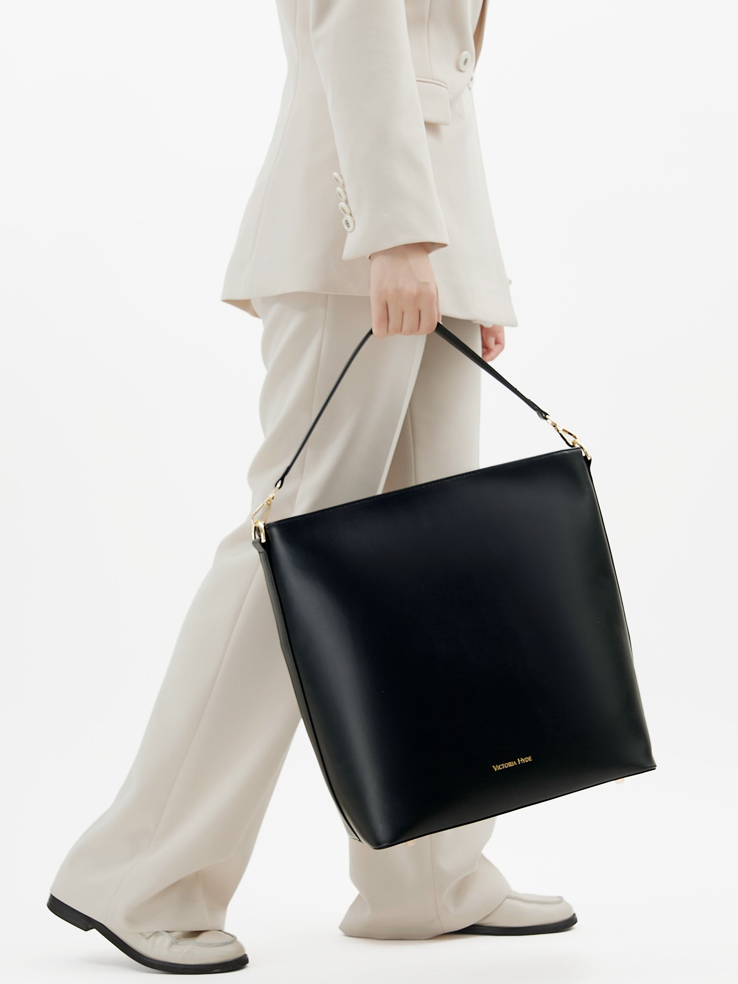 Minimalist black work bag Kloey Large by Victoria Hyde. Vegan, water-repellent, fits 13" laptop. Elegant daily essential for power women.