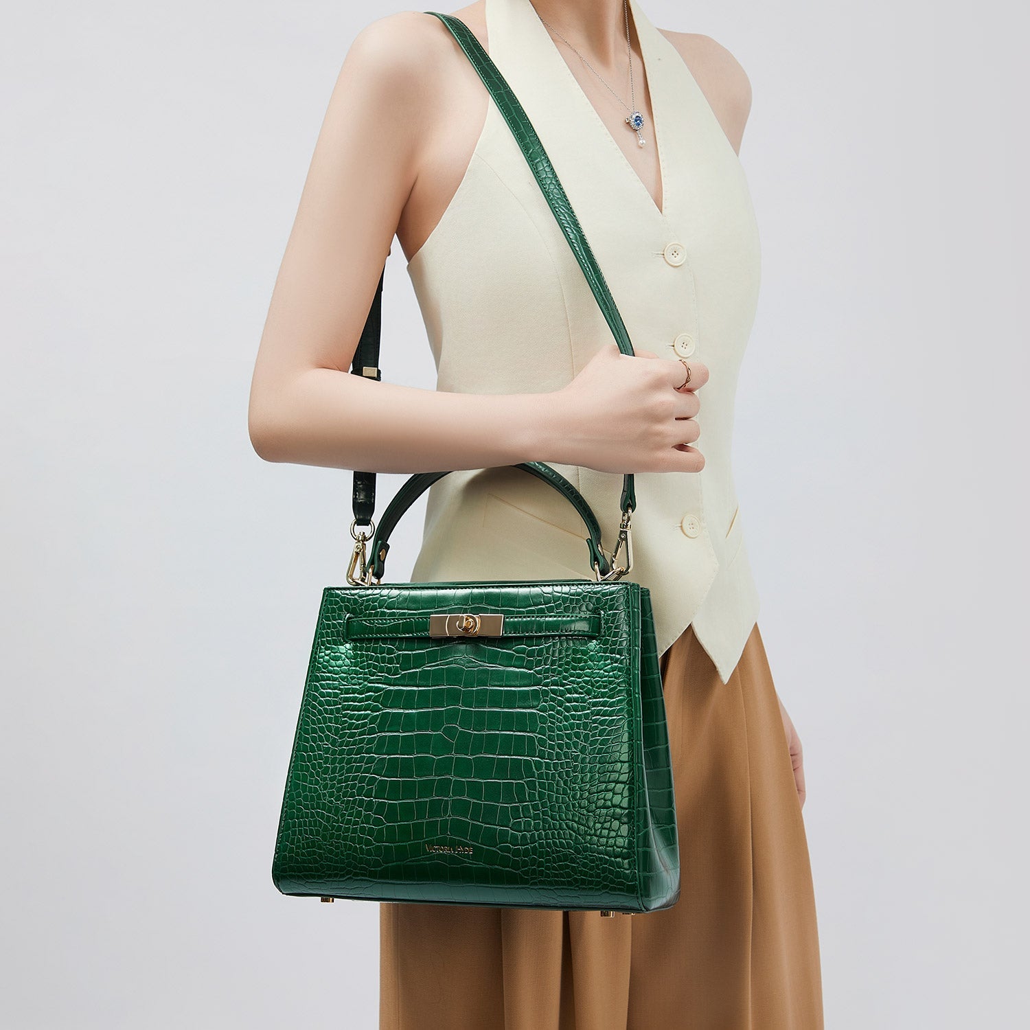 Victoria Hyde Victoria III women's crossbody work bag, trapezoidal synthetic leather, gold clasp, laptop-friendly, organized compartments, ideal for commuting.