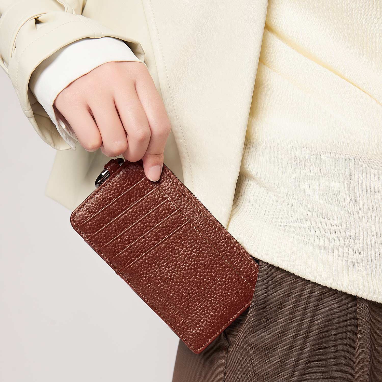 Victoria Hyde caramel genuine leather card holder, unisex & multifunctional. Features 10 card slots, 1 ticket slot, zippered coin pocket, and detachable side closure.