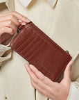 Victoria Hyde caramel genuine leather card holder, unisex & multifunctional. Features 10 card slots, 1 ticket slot, zippered coin pocket, and detachable side closure.