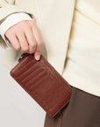 Victoria Hyde caramel genuine leather card holder, unisex & multifunctional. Features 10 card slots, 1 ticket slot, zippered coin pocket, and detachable side closure.