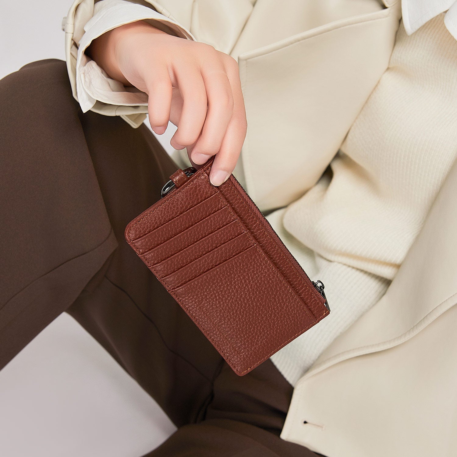 Victoria Hyde caramel genuine leather card holder, unisex & multifunctional. Features 10 card slots, 1 ticket slot, zippered coin pocket, and detachable side closure.