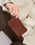Victoria Hyde caramel genuine leather card holder, unisex & multifunctional. Features 10 card slots, 1 ticket slot, zippered coin pocket, and detachable side closure.
