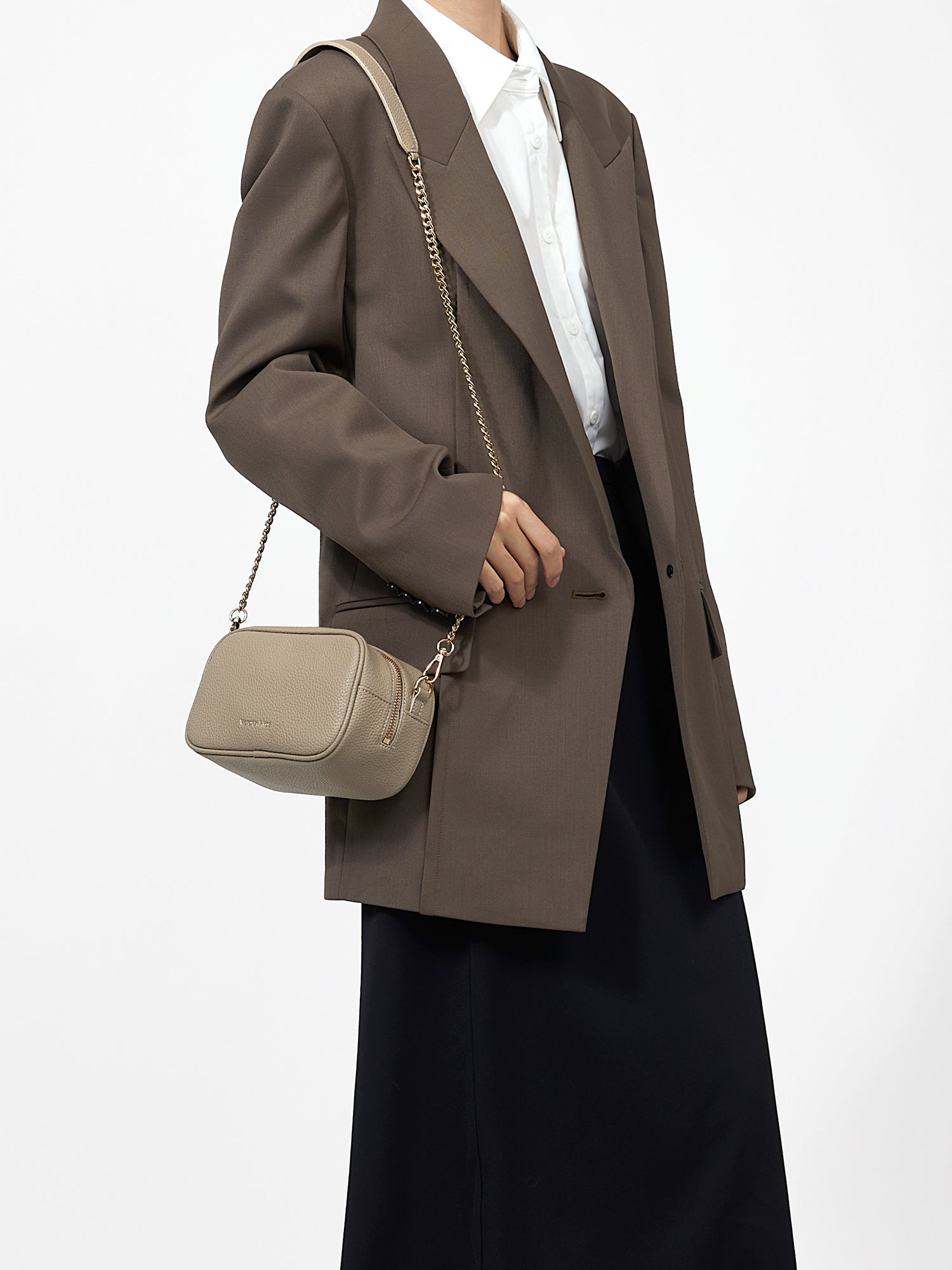 Victoria Hyde Antonia bag, light gold hardware, microfiber with recycled lining. Compact 18x10.5x9 cm, front pockets for keys, lipstick, earphones, slogan "Love what you do."