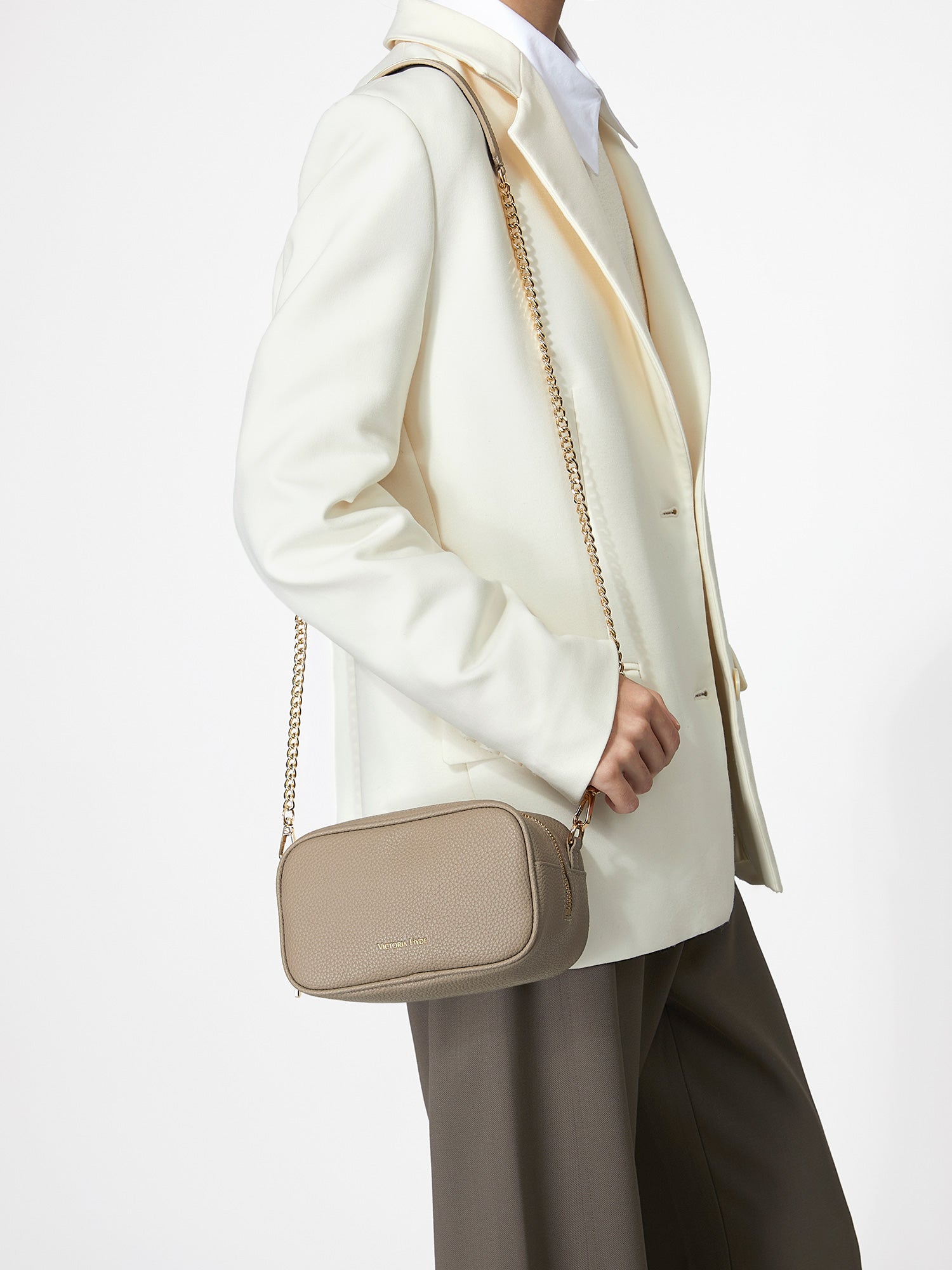Victoria Hyde Antonia bag, light gold hardware, microfiber with recycled lining. Compact 18x10.5x9 cm, front pockets for keys, lipstick, earphones, slogan "Love what you do."
