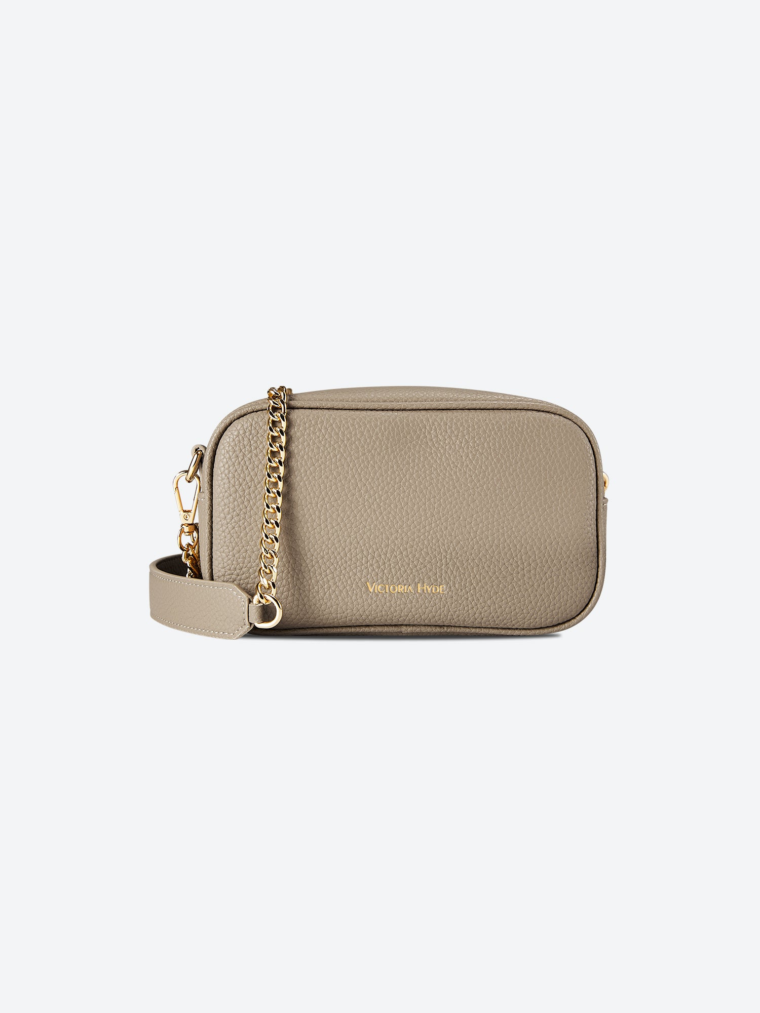Victoria Hyde Antonia bag, light gold hardware, microfiber with recycled lining. Compact 18x10.5x9 cm, front pockets for keys, lipstick, earphones, slogan "Love what you do."