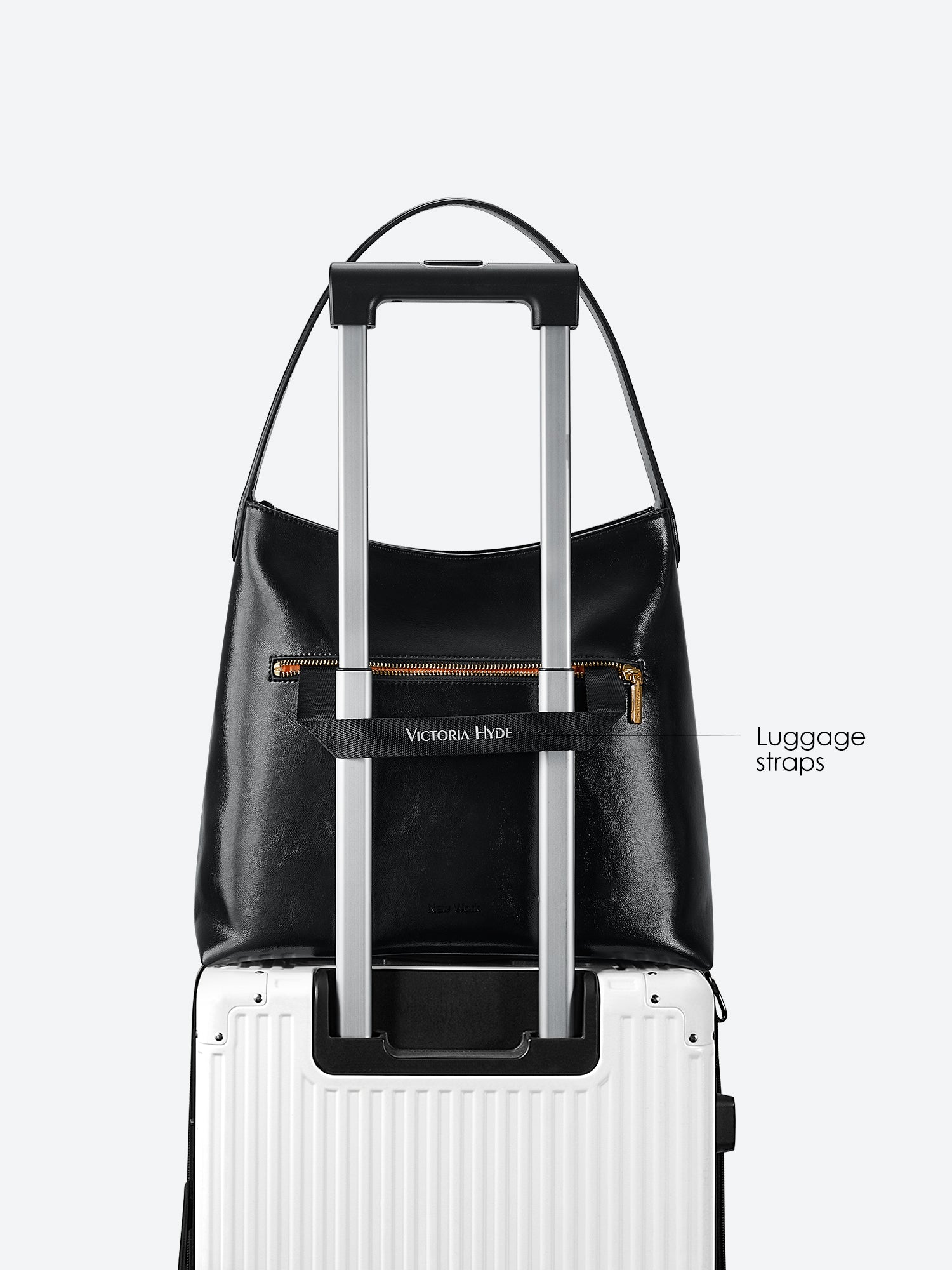 Victoria Hyde shoulder bag in microfiber leather with light gold fittings, padded sunglasses compartment, trolley strap, and inscriptions “Love what you do” and “New Work” for modern dynamic women.