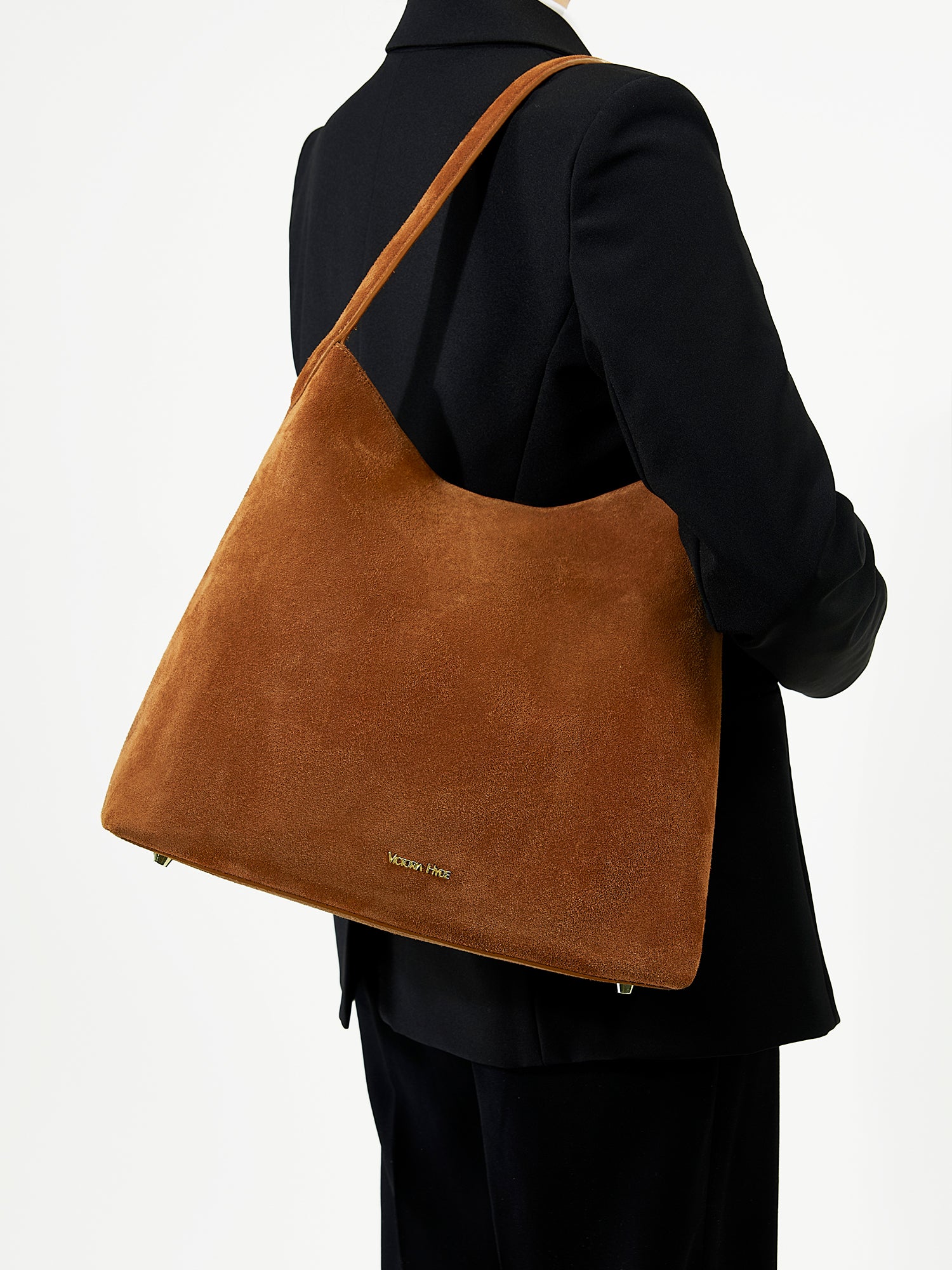 Victoria Hyde split leather shoulder bag for modern women. Light gold fittings, padded sunglasses pocket, trolley strap, “Love what you do” detail. 0.65 kg.