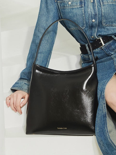 Carol Black Shoulder Bag — modern work bag with organized interior, padded sunglasses pocket, premium microfiber leather, light gold hardware, for women in business.