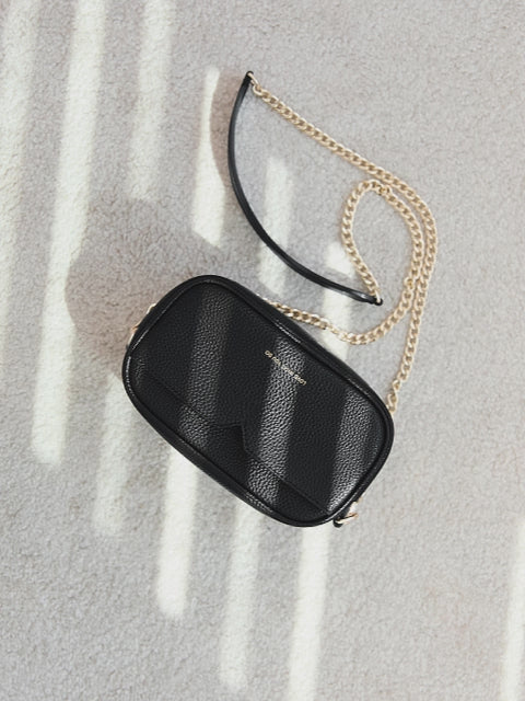 Antonia bag in black by Victoria Hyde London — versatile crossbody and shoulder bag in premium microfiber leather, compact 18×10.5×9 cm, organized pockets for daily essentials, light gold hardware, sustainable recycled lining.